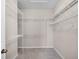 Walk-in closet featuring built-in wire shelving and carpeted flooring at 15863 Citrus Grove Loop, Winter Garden, FL 34787