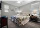 Cozy bedroom featuring a floral-patterned bed, two nightstands, and two windows with blinds at 16033 Citrus Knoll Dr, Winter Garden, FL 34787