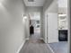 Hallway leads to bedroom and bathroom with carpet flooring and gray walls at 16033 Citrus Knoll Dr, Winter Garden, FL 34787