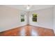 Bright bedroom featuring hardwood floors and multiple windows providing natural light at 1604 Roosevelt Ave, Orlando, FL 32804