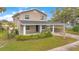 Charming two-story home featuring a covered porch and carport, set in a lush green lawn at 1604 Roosevelt Ave, Orlando, FL 32804