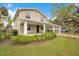 Charming two-story home featuring a covered porch and carport, set in a lush green lawn at 1604 Roosevelt Ave, Orlando, FL 32804