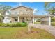 Charming two-story home featuring a covered porch and carport, set in a lush green lawn at 1604 Roosevelt Ave, Orlando, FL 32804