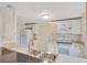 Well-lit kitchen with stainless steel appliances and white cabinets at 1604 Roosevelt Ave, Orlando, FL 32804