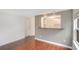 Bright room featuring hardwood floors, a kitchen view, and a window providing natural light at 1604 Roosevelt Ave, Orlando, FL 32804
