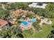 Expansive aerial view of the community pool, clubhouse, and surrounding lush landscaping at 1616 Legacy Park Dr # 1616, Maitland, FL 32751