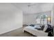 Inviting bedroom featuring a king bed, soft lighting, and a view of the outdoors at 1616 Legacy Park Dr # 1616, Maitland, FL 32751