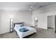 Bright bedroom with neutral tones, fan, and a king bed featuring black frame and white bedding at 1616 Legacy Park Dr # 1616, Maitland, FL 32751