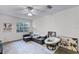 Cozy living room with a ceiling fan, plush sofa, decorative rug, and natural lighting at 1616 Legacy Park Dr # 1616, Maitland, FL 32751