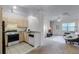 Bright living area with open kitchen, carpeted floors, ceiling fan, and natural light at 1616 Legacy Park Dr # 1616, Maitland, FL 32751