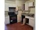 This kitchen features laminate countertops, and a black range oven at 1633 Christopher St, Winter Garden, FL 34787