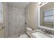 Bathroom featuring tiled walk-in shower, granite vanity, and a framed mirror at 1707 Gammon Ln, Orlando, FL 32811