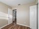 Cozy bedroom featuring wood-look floors and neutral walls with two white doors at 1707 Gammon Ln, Orlando, FL 32811