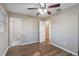 Bright bedroom features wood-look flooring and doors to the bathroom and hallway at 1707 Gammon Ln, Orlando, FL 32811