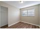 Bedroom featuring wood-look floors, a window with blinds, and a closet for storage at 1707 Gammon Ln, Orlando, FL 32811