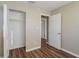 Bedroom featuring a closet and an open door, and wood-look flooring at 1707 Gammon Ln, Orlando, FL 32811