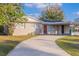 Inviting home showcasing a spacious driveway, a cozy porch, and fresh exterior paint at 1707 Gammon Ln, Orlando, FL 32811