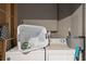 Laundry area with washer, dryer, laundry basket, ironing board, and cleaning supplies at 1707 Gammon Ln, Orlando, FL 32811