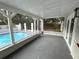 Outdoor patio featuring a pool, white columns, and wood decking at 1712 Lake Lorine Dr, Orlando, FL 32808