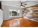 Inviting bedroom featuring wood floors, a decorative wood wall, and an abundance of natural light at 19709 W Eldorado Dr, Eustis, FL 32736