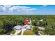 An aerial view showing the home's location amongst the surrounding trees at 2243 Davis Dr, New Smyrna Beach, FL 32168