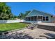 Beautiful backyard with a well-maintained lawn, brick patio, fenced-in yard, and a covered lanai at 2243 Davis Dr, New Smyrna Beach, FL 32168