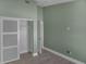 Spacious bedroom featuring light gray wood flooring, a large closet, and modern wall color at 2243 Davis Dr, New Smyrna Beach, FL 32168