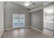 Bright, airy bedroom with hardwood floors, ceiling fan and ensuite bathroom access at 2243 Davis Dr, New Smyrna Beach, FL 32168