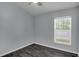 This bedroom has one window, modern flooring and neutral gray paint at 2243 Davis Dr, New Smyrna Beach, FL 32168