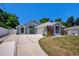 Charming home with a well-manicured lawn and driveway, under a clear blue sky at 2243 Davis Dr, New Smyrna Beach, FL 32168