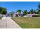 Inviting home with a manicured lawn and a neatly paved driveway at 2243 Davis Dr, New Smyrna Beach, FL 32168