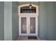 Close up view of the front door with decorative glass panels and a 'Welcome' mat at 2243 Davis Dr, New Smyrna Beach, FL 32168