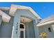 Inviting front entrance featuring a blue archway, house number, and stylish hanging light fixture at 2243 Davis Dr, New Smyrna Beach, FL 32168