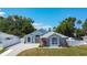 A beautiful single-story home with lush landscaping, a paved driveway, and a charming facade at 2243 Davis Dr, New Smyrna Beach, FL 32168