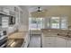 Well-lit kitchen with granite countertops, stainless steel appliances, and wood-look tile flooring at 2243 Davis Dr, New Smyrna Beach, FL 32168