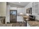 Modern kitchen with stainless steel appliances, granite countertops, and stylish wood-look flooring at 2243 Davis Dr, New Smyrna Beach, FL 32168