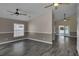 Open-concept living room with modern flooring, a ceiling fan and backyard access at 2243 Davis Dr, New Smyrna Beach, FL 32168