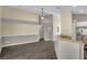Open-concept living area with sleek wood-look flooring, a ceiling fan, and easy kitchen access at 2243 Davis Dr, New Smyrna Beach, FL 32168
