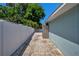 Brick side yard, enclosed by a white fence, offering privacy and a shed for storage at 2243 Davis Dr, New Smyrna Beach, FL 32168