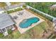 Overhead view of a gorgeous outdoor space with custom shaped pool, patio, and fire pit area at 2503 Lassek Dr, Orlando, FL 32806