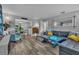 Comfortable living room featuring hardwood floors, a stylish sofa, and ample natural light at 2503 Lassek Dr, Orlando, FL 32806