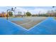 Vibrant community basketball court featuring a colorful playing surface with hoops, lighting, and a nearby playground at 2611 Gala N Rd # 105, Kissimmee, FL 34746