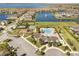 Community aerial view featuring a pool, clubhouse, playground, parking, and scenic water views at 2613 Mead Ave, St Cloud, FL 34771