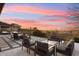 Spacious backyard patio featuring ample seating, a fire pit, and views of the sunset at 2613 Mead Ave, St Cloud, FL 34771