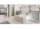 Bright bathroom features a soaking tub, marble floors, gray cabinets, and granite countertops at 2613 Mead Ave, St Cloud, FL 34771