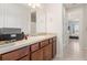 Bathroom featuring wood cabinets, neutral countertops, a large mirror, and access to another room at 2613 Mead Ave, St Cloud, FL 34771