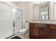 Cozy bathroom featuring tiled shower with glass door, dark wood vanity, and modern fixtures at 2613 Mead Ave, St Cloud, FL 34771