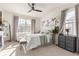 Comfortable bedroom with large window, ceiling fan, neutral colors, and natural light at 2613 Mead Ave, St Cloud, FL 34771