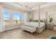 Bright bedroom with a four-poster bed, tray ceiling, and large windows offering natural light at 2613 Mead Ave, St Cloud, FL 34771