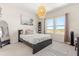 Bright bedroom features neutral decor, large windows with views, and a woven pendant light fixture at 2613 Mead Ave, St Cloud, FL 34771
